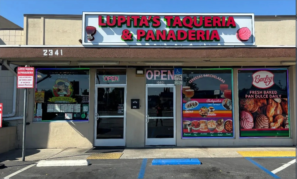Lupita’s storefront with the red and green Lupita’s Taqueria and Panaderia sign above the 2341 entrance